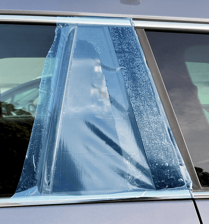 Smashwrap adhesive film covering broken car window