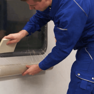 applying self adhesive glass protection film with squeegee