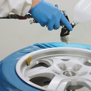 Alloy wheel being spray painted with Wondermask WPS masking film applied