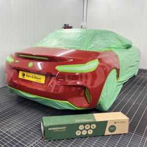 recycled automotive masking film covering car in spray booth
