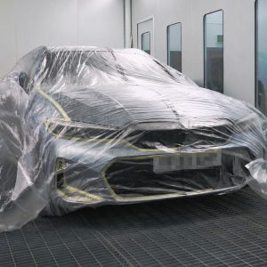 automotive masking film applied to vehicle in spraybooth
